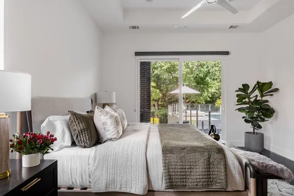 a bedroom with a bed and a potted plant
