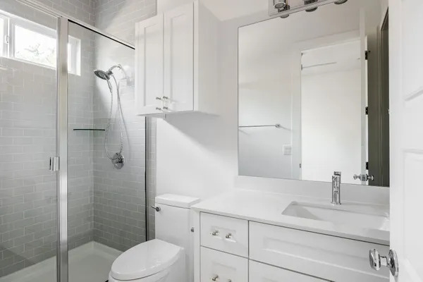 a bathroom with a sink toilet and shower