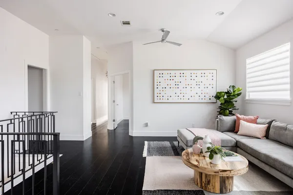 a living room with furniture and a chandelier