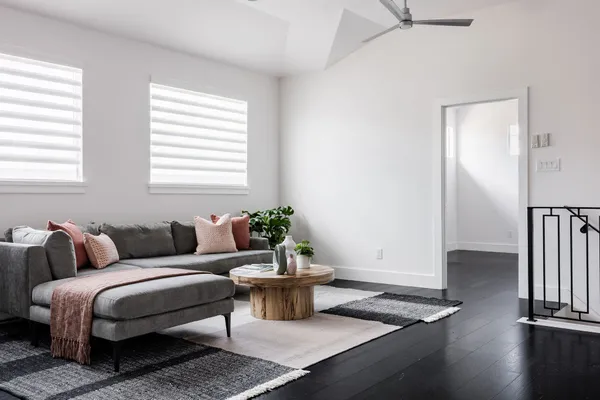 a living room with furniture a wooden floor and a window