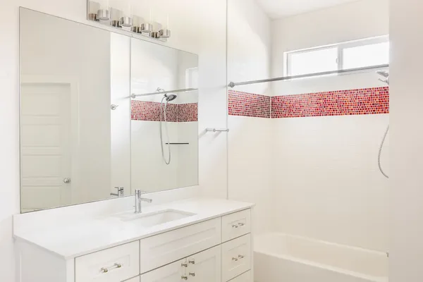 a bathroom with a sink and a mirror