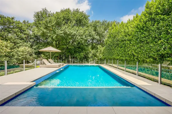 a view of a swimming pool with a lounge chair