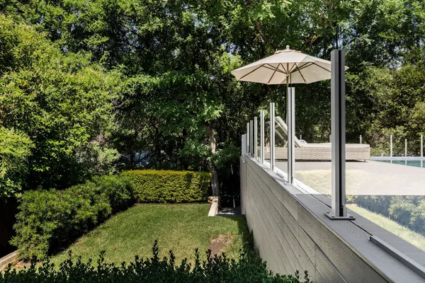 a view of a patio with chairs under an umbrella