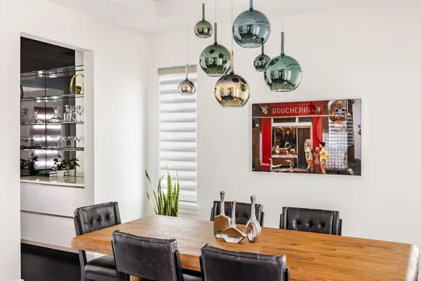 a view of a dining room with furniture and chandelier