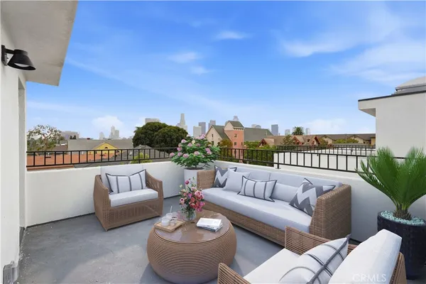 a balcony with furniture and a potted plant