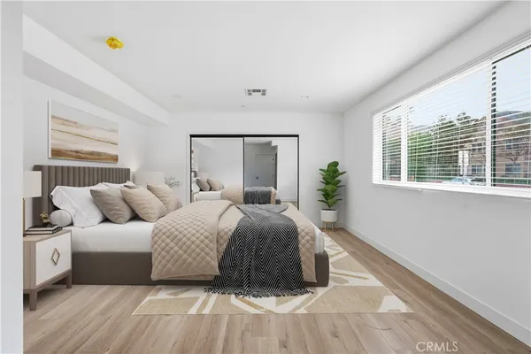 a spacious bedroom with a bed and a window