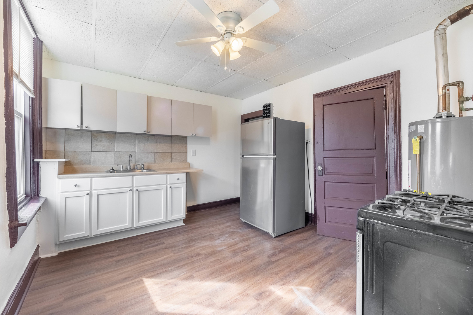 1115 West 17th Street, Unit 2F Chicago, IL 60608 - Photo 14 of 28 a kitchen with a refrigerator and a stove top oven
