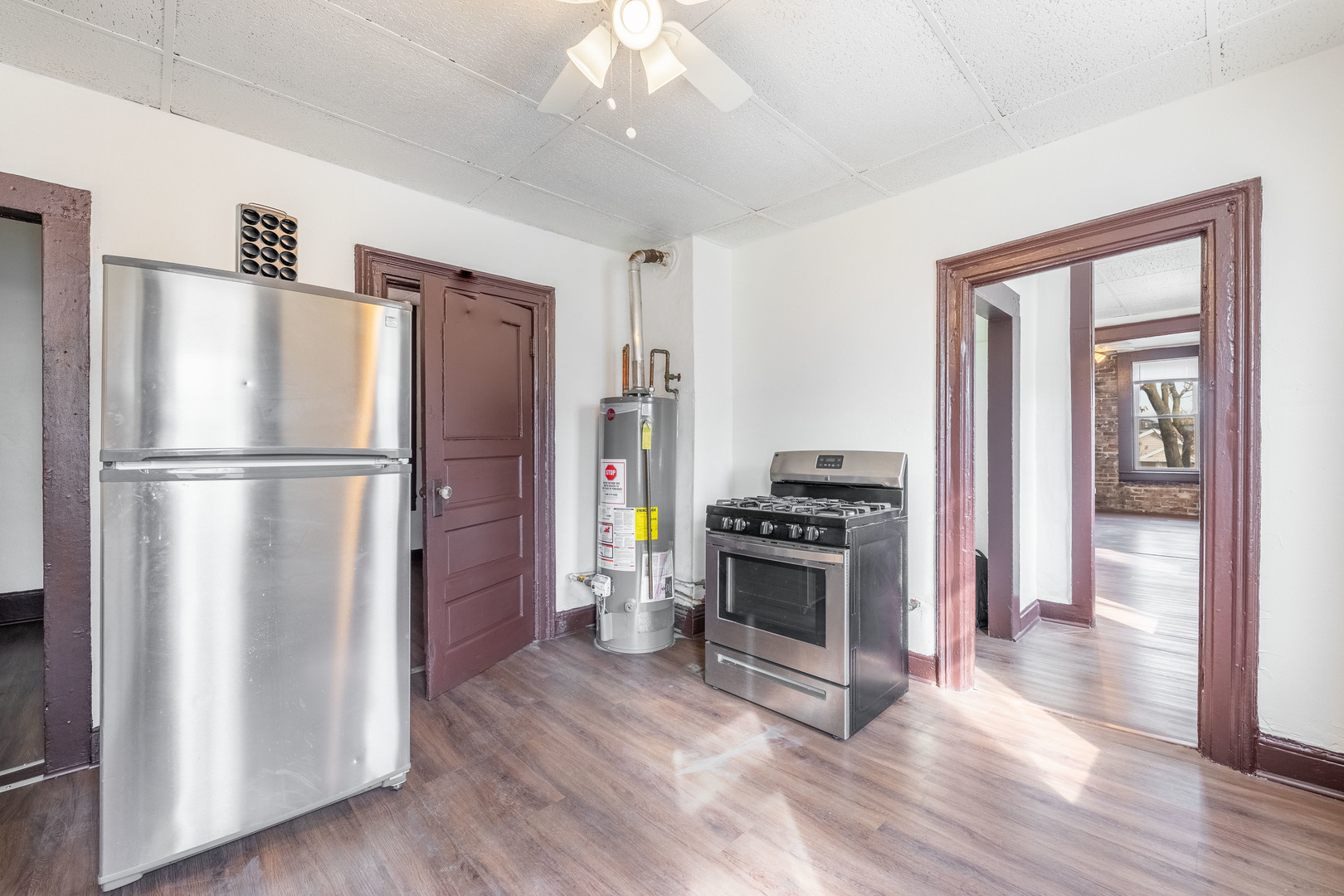 1115 West 17th Street, Unit 2F Chicago, IL 60608 - Photo 16 of 28 a kitchen with stainless steel appliances granite countertop a refrigerator stove and wooden floor