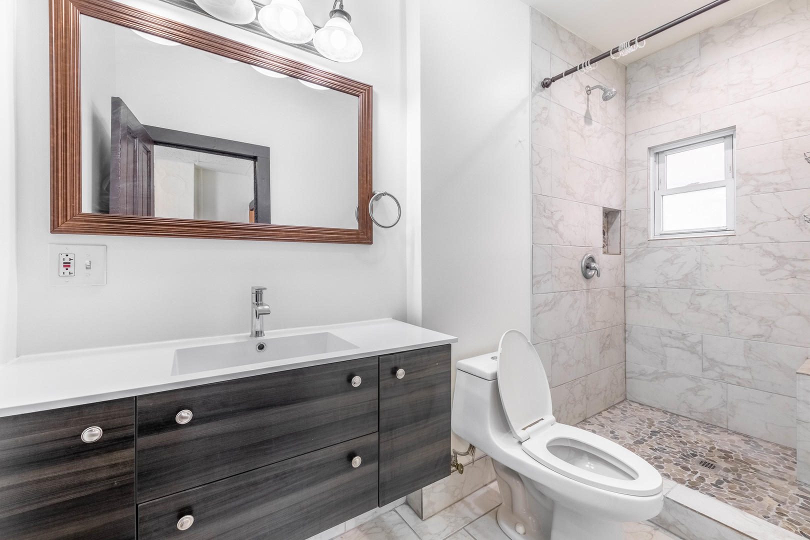1115 West 17th Street, Unit 2F Chicago, IL 60608 - Photo 18 of 28 a bathroom with a sink a toilet a mirror and shower