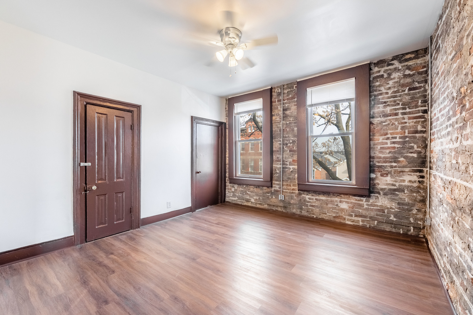 1115 West 17th Street, Unit 2F Chicago, IL 60608 - Photo 6 of 28 a view of an empty room with a window and wooden floor