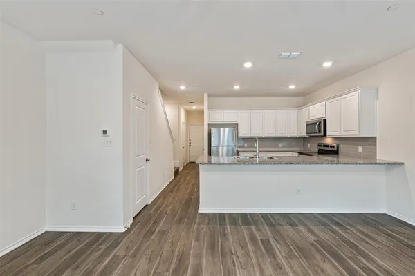 a view of kitchen with wooden floor