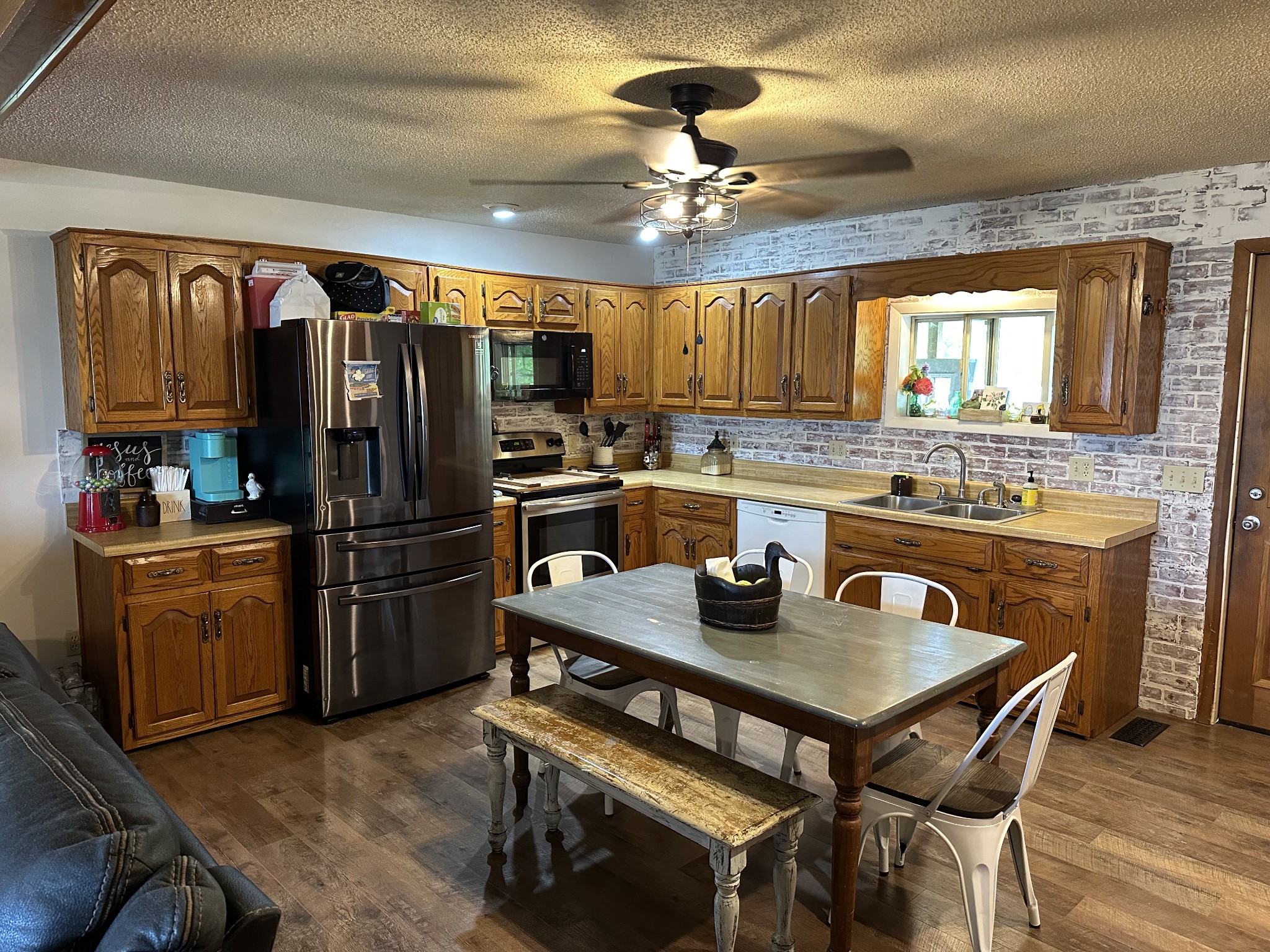 88 Rose Hill Road Red Boiling Springs, TN 37150 - Photo 8 of 35 a kitchen with stainless steel appliances granite countertop a stove a refrigerator a sink a dining table and chairs