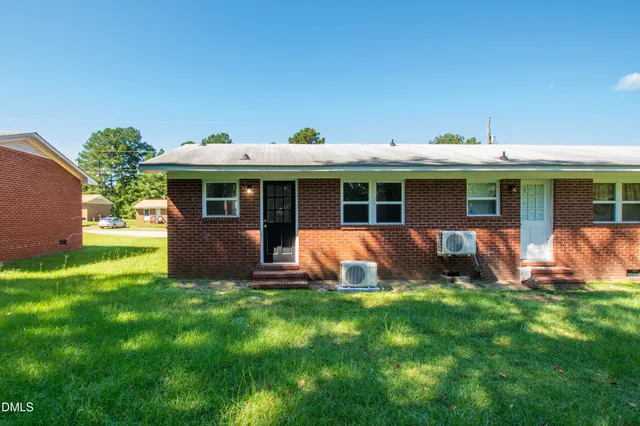 a view of house with backyard