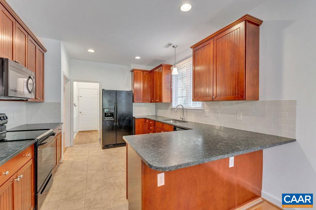 1245 Amber Ridge Road Charlottesville, VA 22901 - Photo 12 of 29 a kitchen with a sink a counter top space cabinets and stainless steel appliances