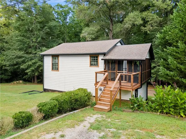 a view of a house with a yard and sitting area