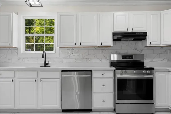 a kitchen with a refrigerator sink and cabinets