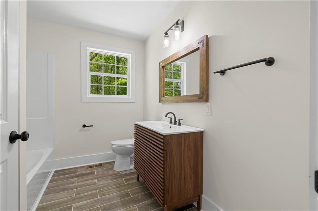 1271 Hayes Street Madison, GA 30650 - Photo 14 of 37 a bathroom with a sink toilet and a window