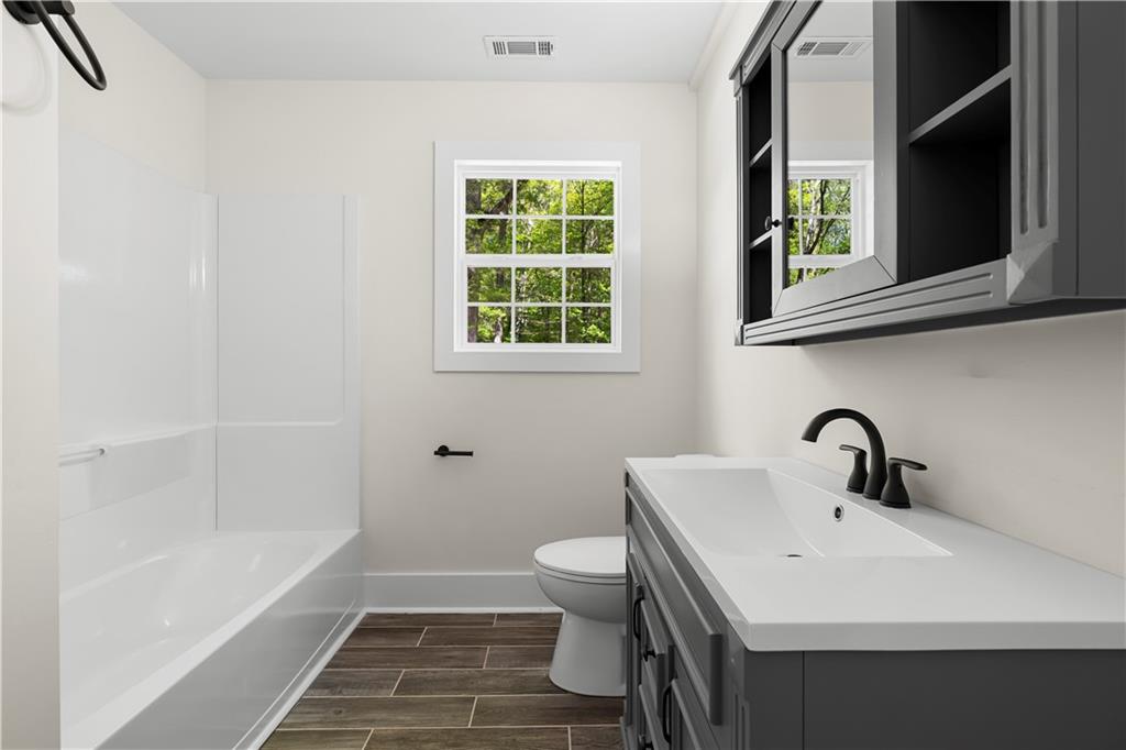 1271 Hayes Street Madison, GA 30650 - Photo 20 of 37 a bathroom with a sink and a mirror