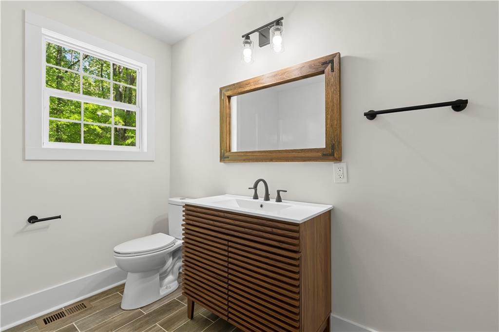 1271 Hayes Street Madison, GA 30650 - Photo 22 of 37 a bathroom with a toilet sink and mirror