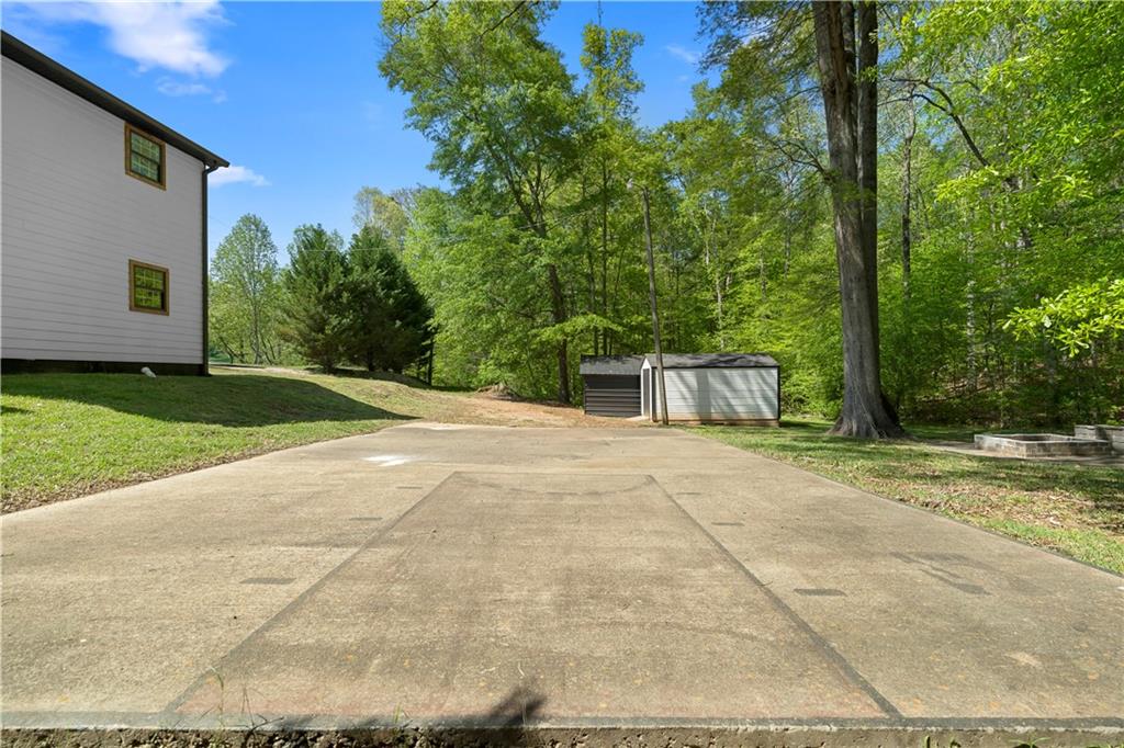 1271 Hayes Street Madison, GA 30650 - Photo 29 of 37 a front view of a house with a yard and garage