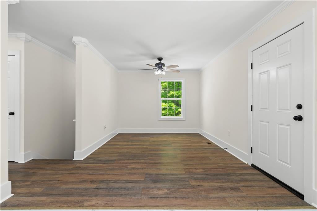 1271 Hayes Street Madison, GA 30650 - Photo 6 of 37 wooden floor in an empty room with a window