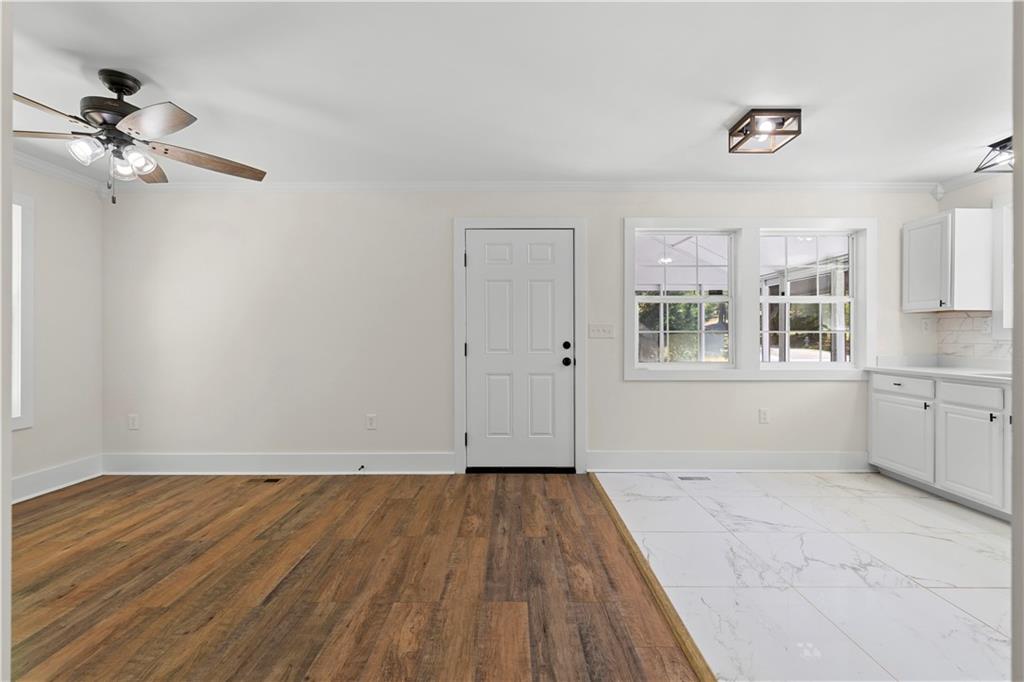 1271 Hayes Street Madison, GA 30650 - Photo 8 of 37 a view of empty room with wooden floor and fan