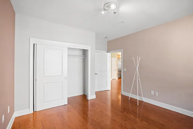 a view of an empty room with wooden floor