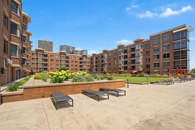 a building view with outdoor space swimming pool and trees in the background