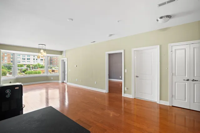a view of a room with wooden floor