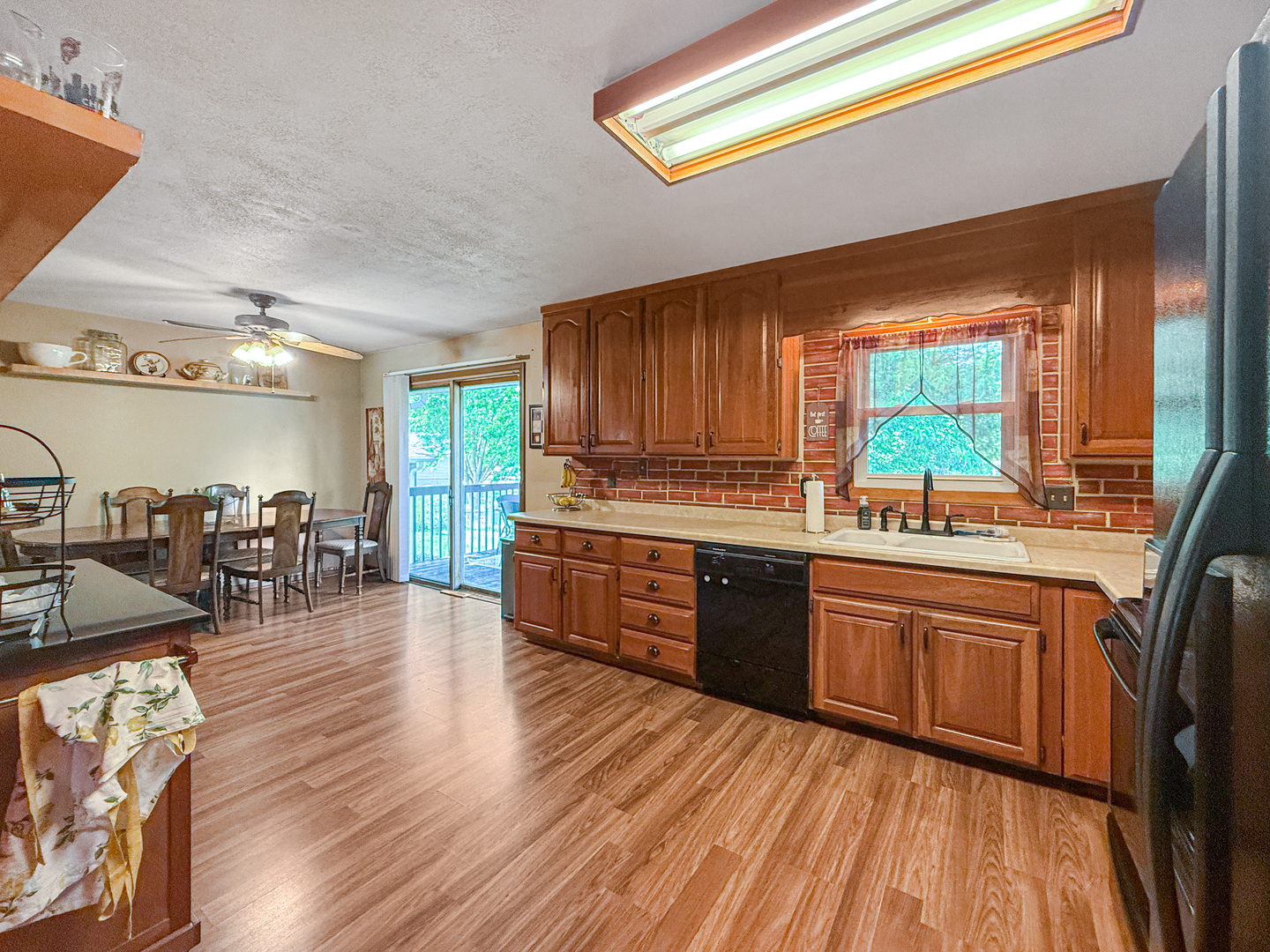 3288 Knox Drive Freeport, IL 61032 - Photo 12 of 41 a kitchen with stainless steel appliances granite countertop wooden cabinets a stove a sink and a large window