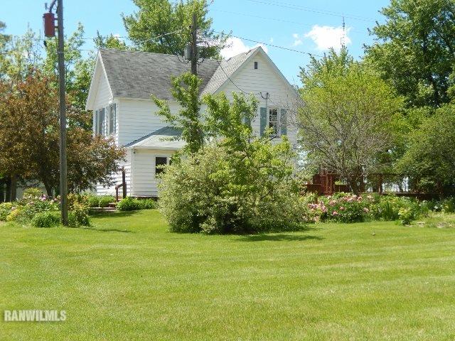 15978 West Harper Road Forreston, IL 61030 - Photo 3 of 24 a front view of a house with garden