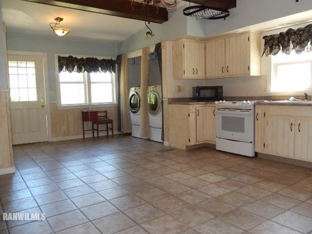 15978 West Harper Road Forreston, IL 61030 - Photo 5 of 24 a kitchen with a refrigerator and white cabinets