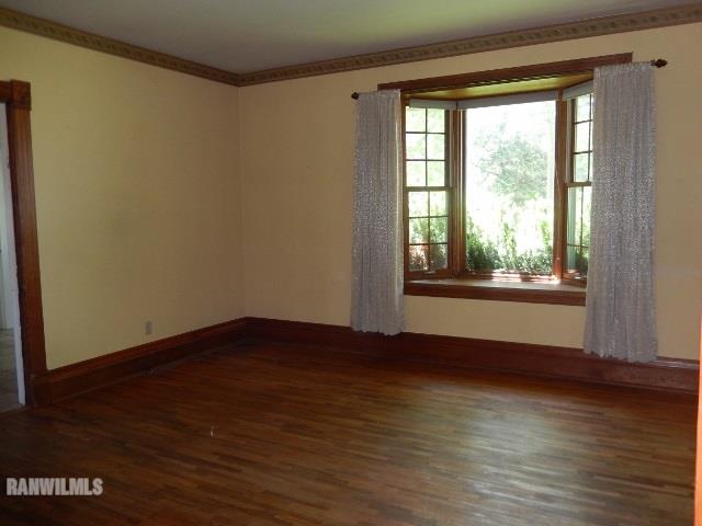 15978 West Harper Road Forreston, IL 61030 - Photo 6 of 24 a view of an empty room with wooden floor and a window