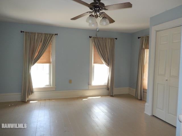 15978 West Harper Road Forreston, IL 61030 - Photo 10 of 24 an empty room with wooden floor and windows