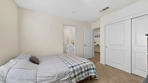 a bedroom with a bed and closet