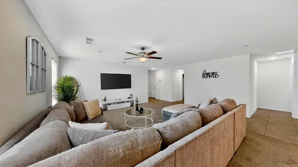 a kitchen with stainless steel appliances kitchen island sink refrigerator and cabinets