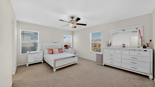 a room with a bed and a large window