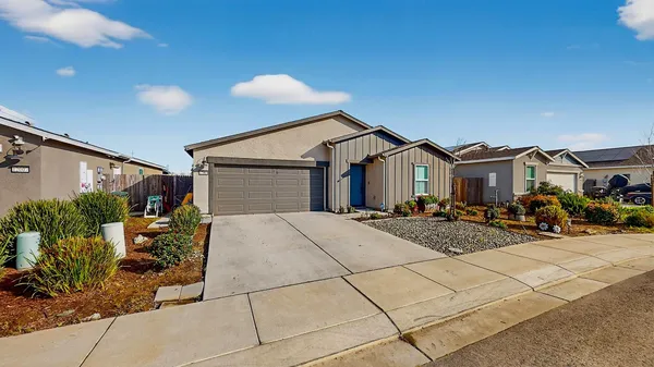 a front view of a house with garden