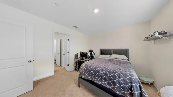 a bedroom with a bed and a table