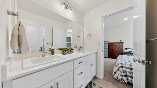 a bathroom with a double vanity sink and a mirror
