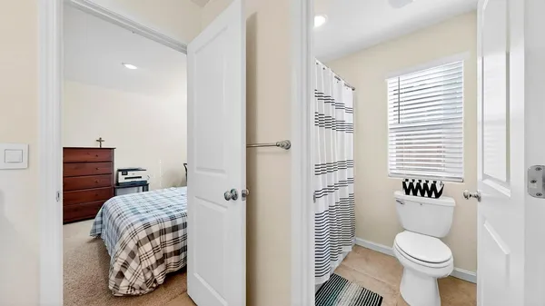 a bathroom with a toilet and a shower