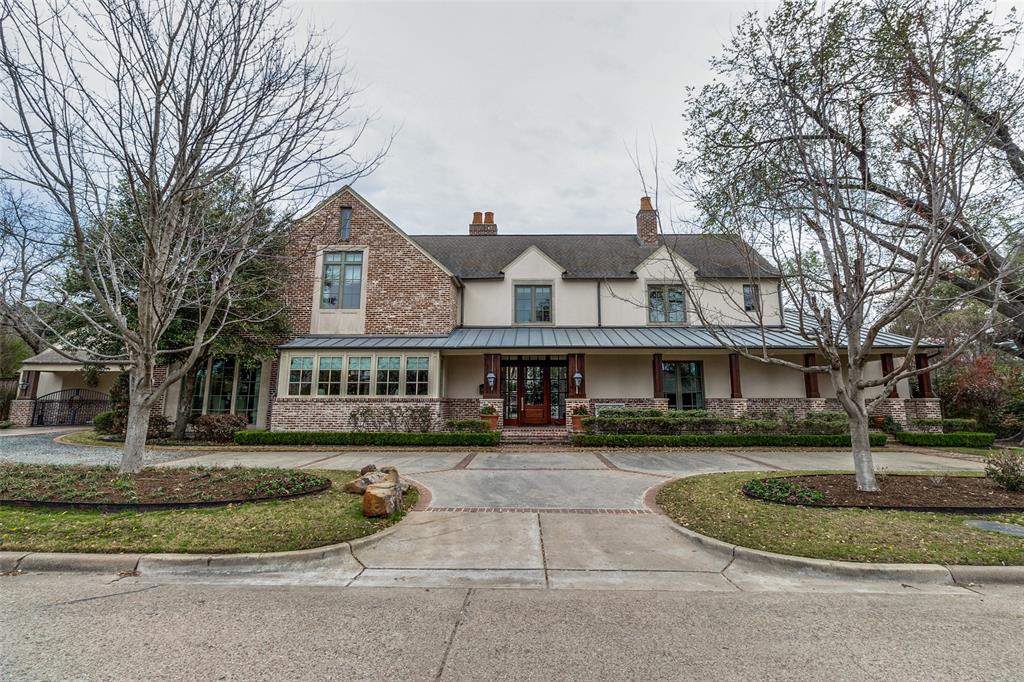 a front view of residential houses with yard and green space