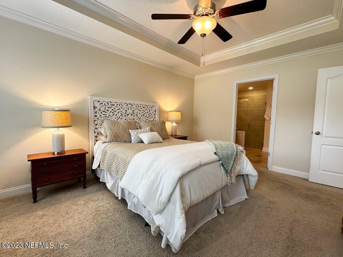 67 Salt Point St. Augustine, FL 32086 - Photo 15 of 39 a bedroom with a bed and lamp