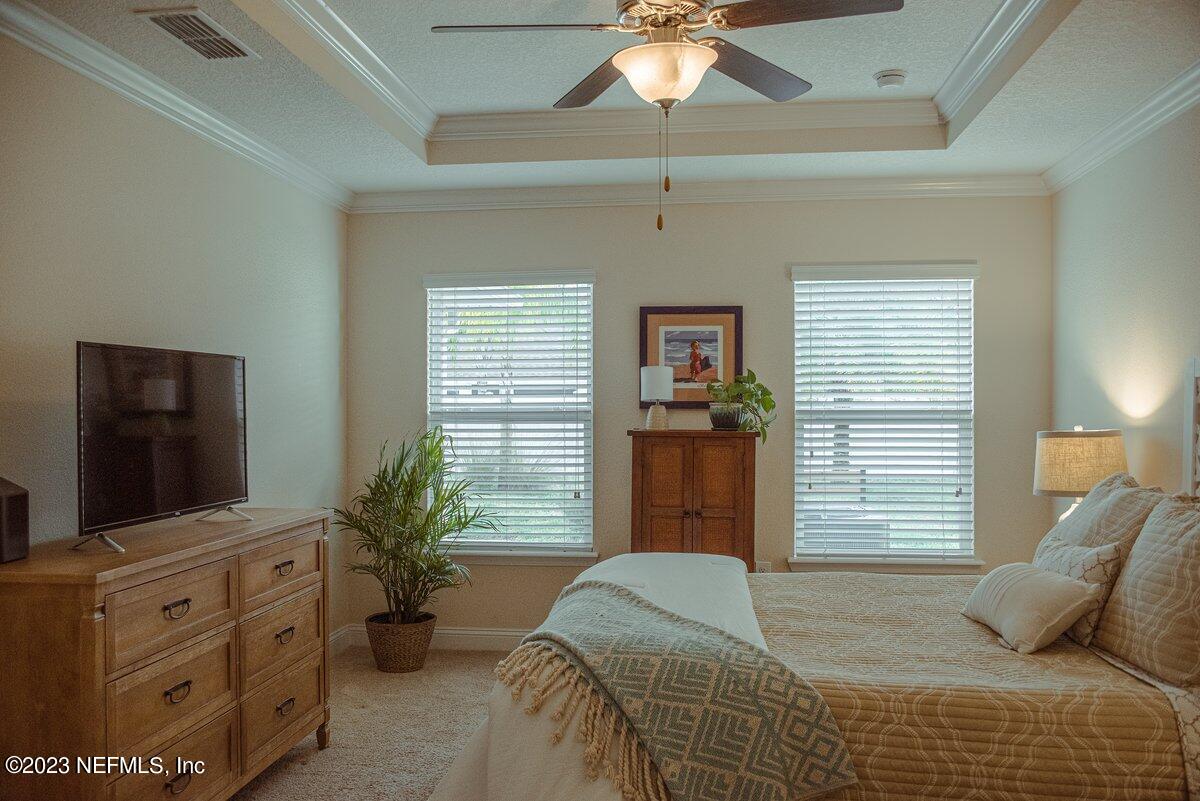 67 Salt Point St. Augustine, FL 32086 - Photo 16 of 39 a bedroom with a bed and a flat screen tv