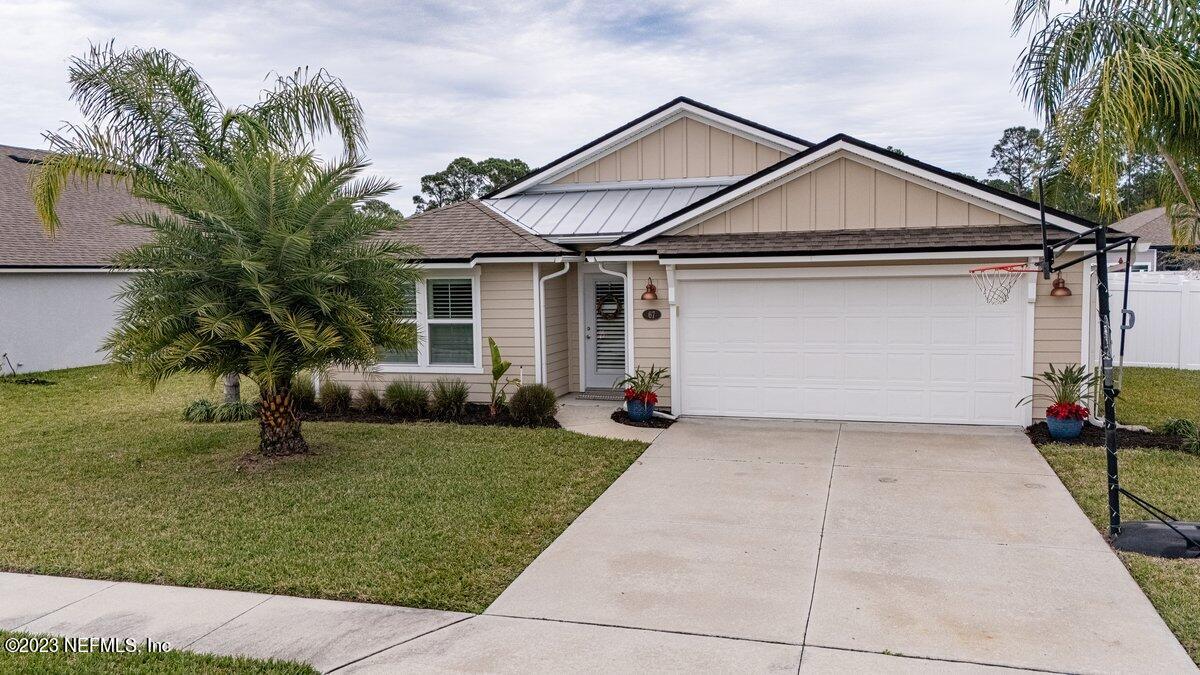 67 Salt Point St. Augustine, FL 32086 - Photo 2 of 39 a front view of a house with a yard
