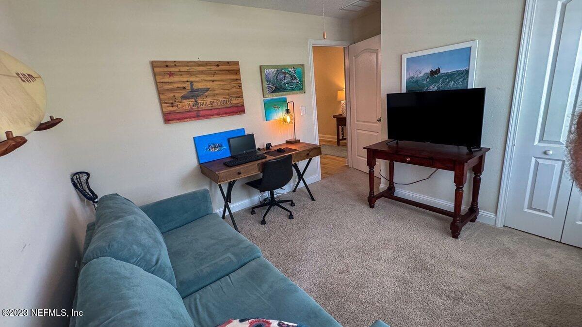 67 Salt Point St. Augustine, FL 32086 - Photo 24 of 39 a living room with furniture and a flat screen tv