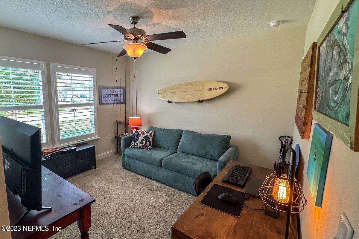 67 Salt Point St. Augustine, FL 32086 - Photo 26 of 39 a living room with furniture and a flat screen tv