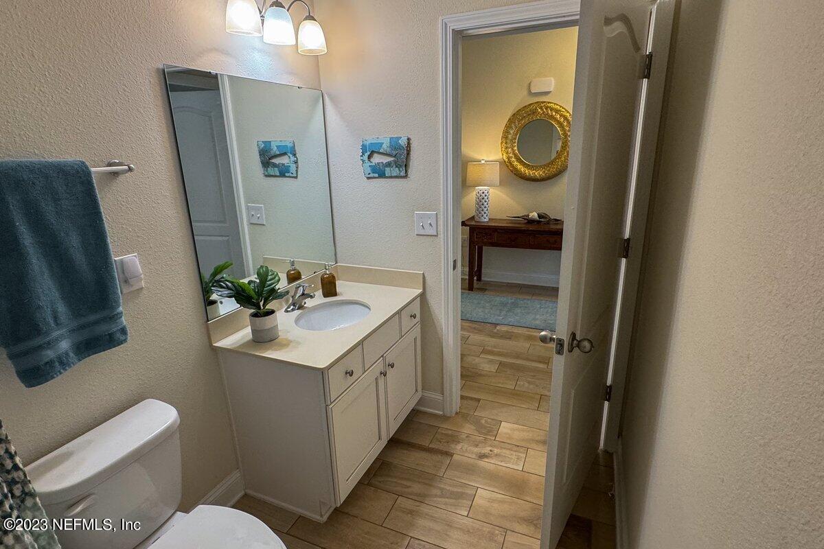 67 Salt Point St. Augustine, FL 32086 - Photo 28 of 39 a bathroom with a sink a toilet and a mirror