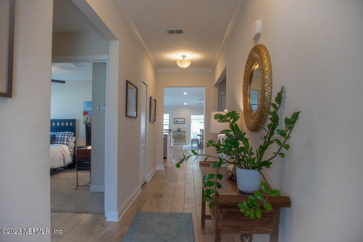 67 Salt Point St. Augustine, FL 32086 - Photo 7 of 39 a hallway with beautiful flowers and wooden floor