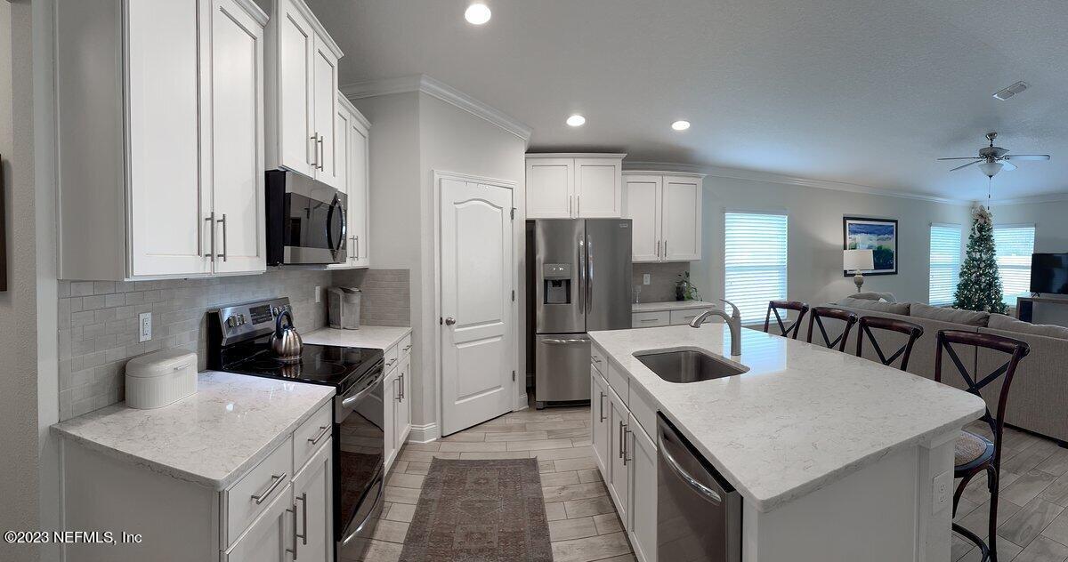 67 Salt Point St. Augustine, FL 32086 - Photo 9 of 39 a kitchen that has a sink a counter space and stainless steel appliances